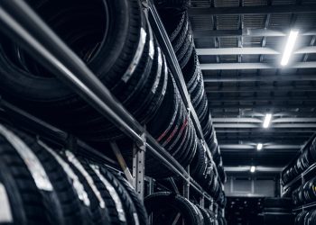 Dark storage full or big variety of new tyres at busy warehouse.