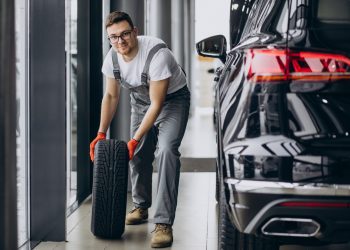 Mechanic changing tires in a car service